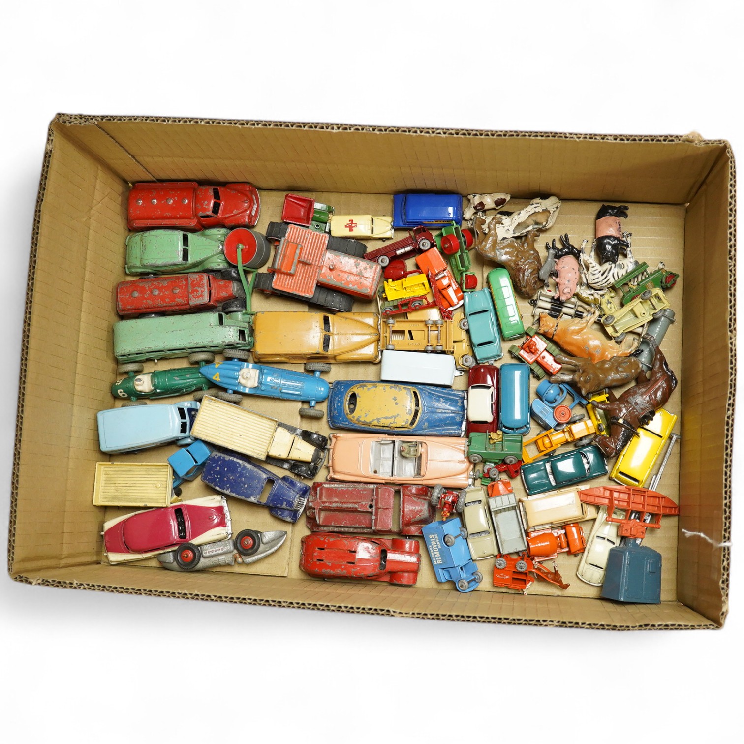 Fifty 1950s/60s diecast vehicles, by Matchbox, Dinky Toys, Charbens, etc. including thirty Matchbox Series vehicles, dinky cars and commercial vehicles, a Charbens fire engine, and a few Britains lead animals. Condition